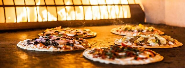 A look into their amazing pizza oven. Photo courtesy Pizza Rev.